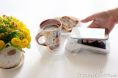 Contactless payment through mobile phone on pos terminal Stock Photo