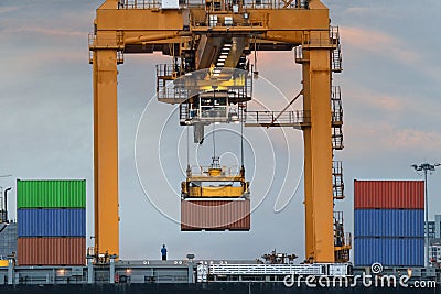 Container Cargo freight ship with working crane loading bridge i Stock Photo