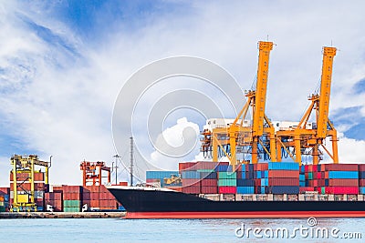Container cargo freight ship with working crane loading bridge Stock Photo