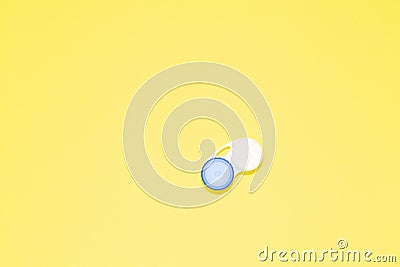Container for contact lenses on yellow background Stock Photo