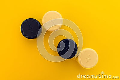 Container for contact lenses on yellow background Stock Photo