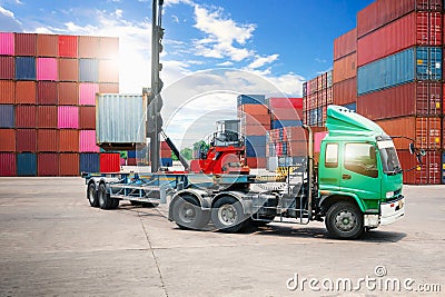 Container Crane Tractor Lifting up Container Box on Trailer Truck. Cargo Container ships, Freight Trucks Import-Export. Stock Photo