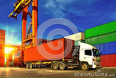 Container handling. Container truck picking up container at yard. Port logistics, container yard operation Stock Photo