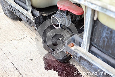 Container for hazardous chemical waste are Leaking from the valve Stock Photo