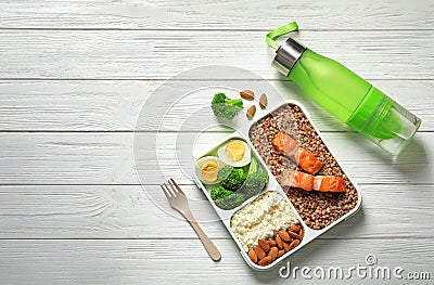 Container with natural healthy lunch, bottle of water and space for text on table, top view. High protein food Stock Photo