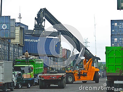 Container reach stacker in action stock photo Editorial Stock Photo