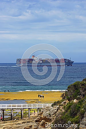 Container ship with people nearby in Victoria, Australia. Editorial Stock Photo