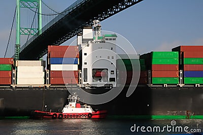 Container ship and red tugboat Stock Photo