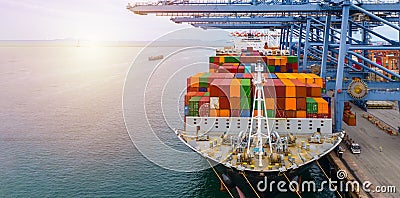 Container ship terminal, Unloading and loading crane of container ship at Industrial port with shipping containers Stock Photo