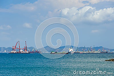 Container ships anchor along a deep seaport in daylight Editorial Stock Photo