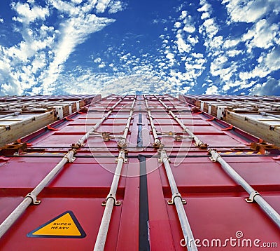 Low angle of container stack inside container yard. Container port terminal operations. Stock Photo