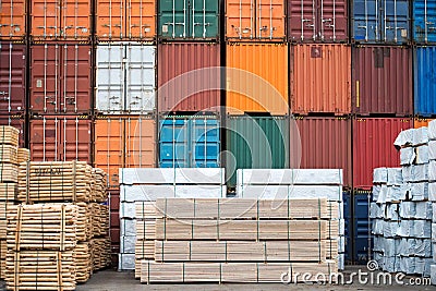 Containers and neatly stacked timber stock. Stock Photo