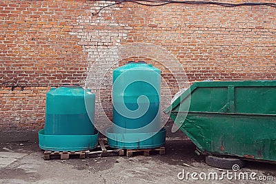Containers with waste engine oil for disposal and trash bin Stock Photo