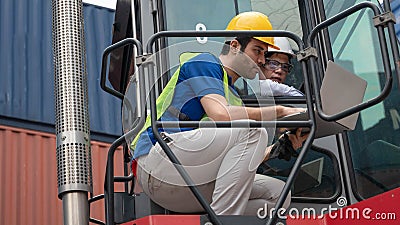 Containers yard management supervisor with container forklift driver in coversation for manage containers yard arrangement at Stock Photo