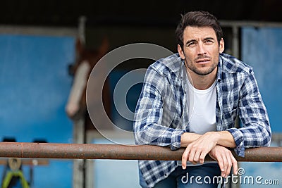 contemplative man at equestrian stables Stock Photo