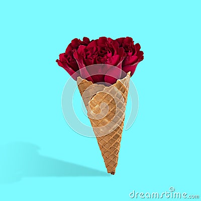 Contemporary art collage, modern design. Summertime mood. Icecream filled with beautiful red roses on light blue Stock Photo