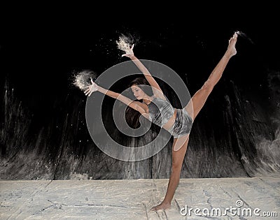 Contemporary ballet dancer dancing on the stage with flour Stock Photo