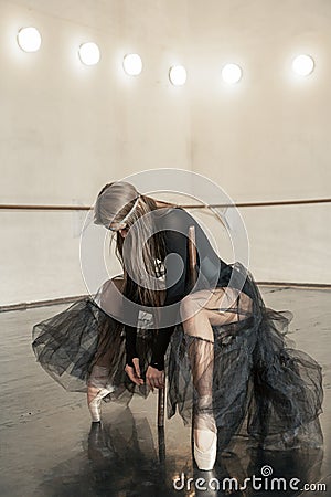 Contemporary ballet dancer on a wooden chair on a repetition Stock Photo