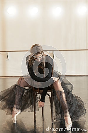 Contemporary ballet dancer on a wooden chair on a repetition Stock Photo