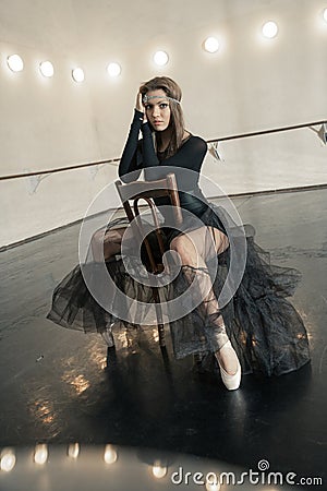 Contemporary ballet dancer on a wooden chair on a repetition Stock Photo