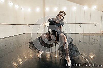 Contemporary ballet dancer on a wooden chair on a repetition Stock Photo