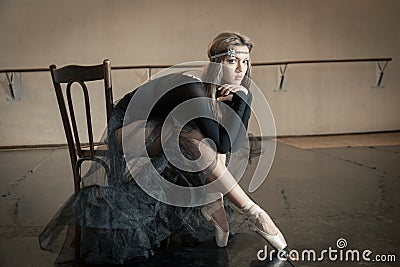 Contemporary ballet dancer on a wooden chair on a repetition Stock Photo