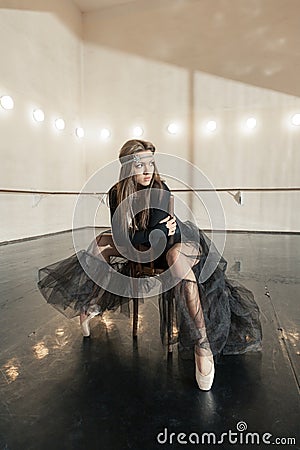 Contemporary ballet dancer on a wooden chair on a repetition Stock Photo