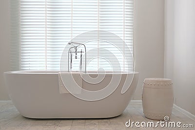 Contemporary bathtub with traditional faucets Stock Photo