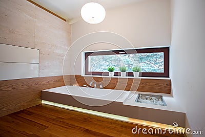 Contemporary bathtub in wooden bathroom Stock Photo