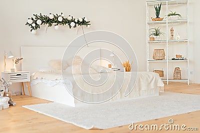 Contemporary big bright white bedroom with shelves. New house. Stock Photo