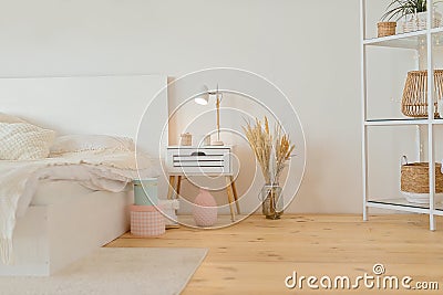 Contemporary big bright white bedroom with shelves. New house. Stock Photo