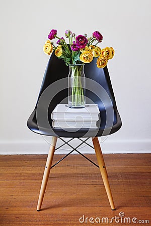 Contemporary black dining chair with yellow and purple flowers Stock Photo