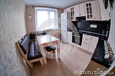 Contemporary black and white kitchen with functional cupboards and modern equipment fisheye photo Stock Photo