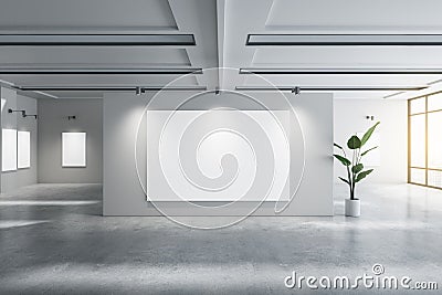 Contemporary concrete gallery interior with empty white mock up posters and decorative plant. Exhibition concept. Stock Photo