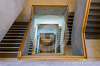 Contemporary concrete staircase with wooden handrail Stock Photo