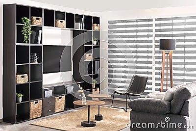 Contemporary living room features large shelves and two comfortable chairs Stock Photo