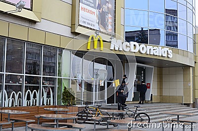 Contemporary McDonald`s Restaurant Exterior.McDonald`s fast food restaurant - window with logo Editorial Stock Photo