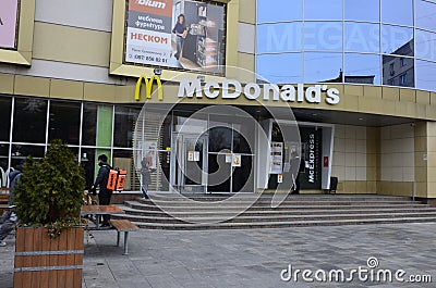 Contemporary McDonald`s Restaurant Exterior.McDonald`s fast food restaurant - window with logo Editorial Stock Photo