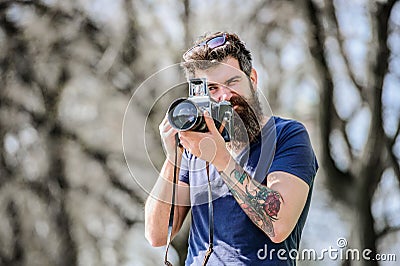 Content creator. Man bearded hipster photographer. Photographer with beard and mustache. Man with long beard shooting Stock Photo