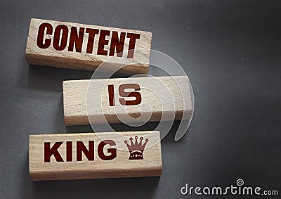 Content is king words on wooden blocks on dark grey background. Copywriting storytelling concept Stock Photo