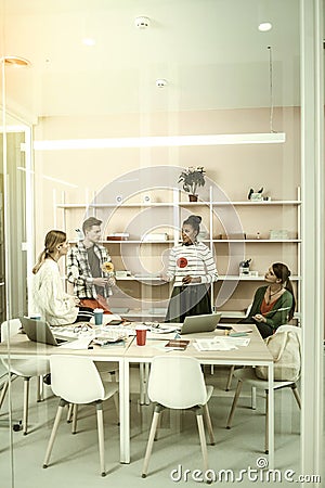 Content managers sitting in light office and using thinking hats Stock Photo