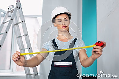 Content skilled builder holding a measuring tape Stock Photo