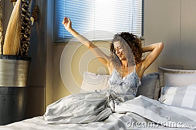 Contented refreshed young woman waking up Stock Photo