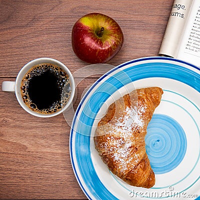 Continental breakfast with coffee, fresh croissants, fruit and good magazine Stock Photo