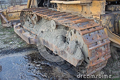 Continuous caterpillar tracks of the bulldozer. Old abandoned bulldozer. Old rusty and weathered bulldozers Stock Photo