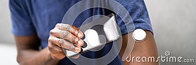 Continuous Glucose Blood Check Using Smartphone. Patient Stock Photo