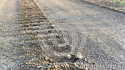 Continuous Iron Crawler Track trail Marks Imprint Open Dusty gravel Road Tractor Bulldozer Backhoe marks Stock Photo