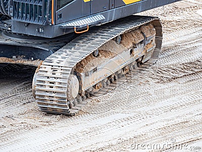 Continuous tracks on a heavy excavator digger machine with track detail Stock Photo