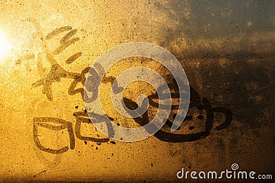 Contour drawing of a teapot and two cups on a foggy window Stock Photo