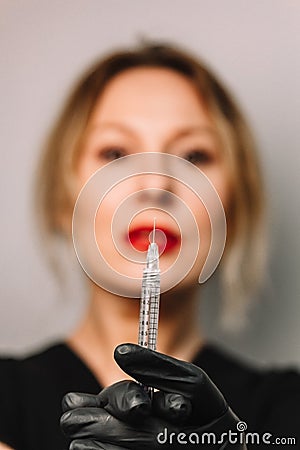 Contour plastic. A cosmetologist injects a botulinum toxin to tighten and smooth out wrinkles on the skin of a female face Stock Photo